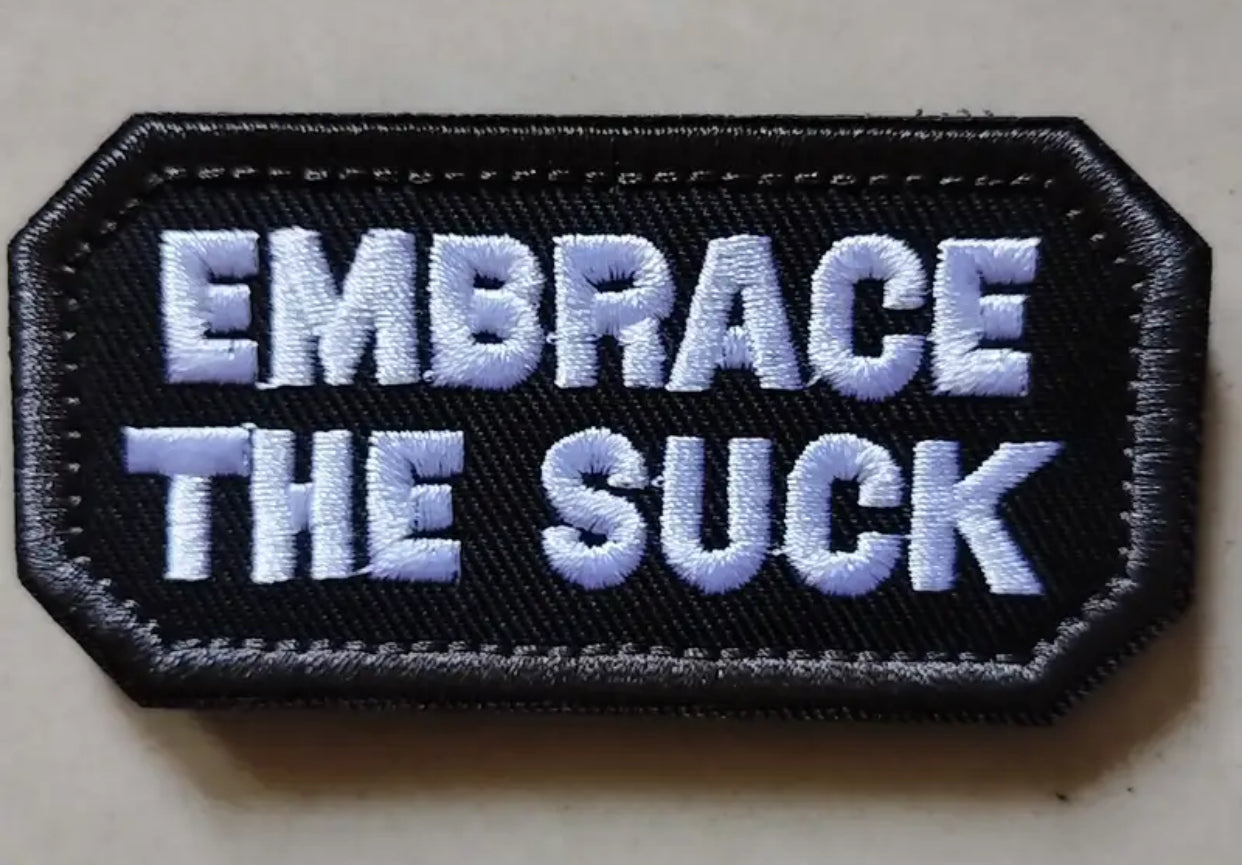 Embrace The Suck Hexagon Embroidered Patch with Hook and Loop Backing
