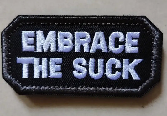 Embrace The Suck Hexagon Embroidered Patch with Hook and Loop Backing